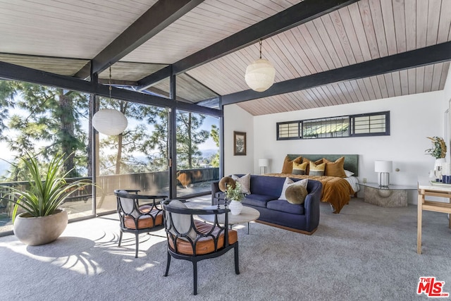 carpeted living room with floor to ceiling windows and vaulted ceiling with beams