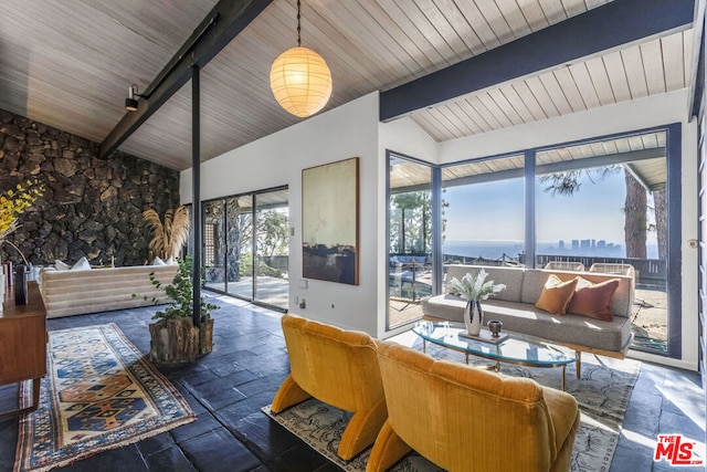 sunroom featuring wood ceiling and vaulted ceiling with beams