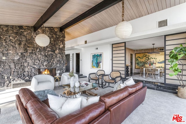 carpeted living room with vaulted ceiling with beams and wood ceiling