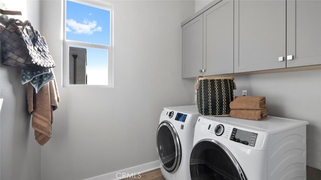 laundry room with cabinets and washing machine and dryer