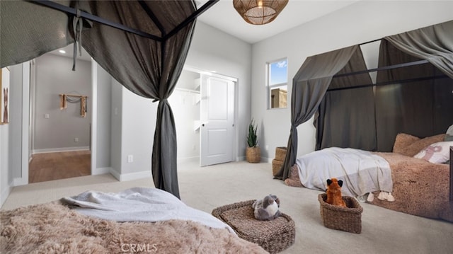 carpeted bedroom with lofted ceiling