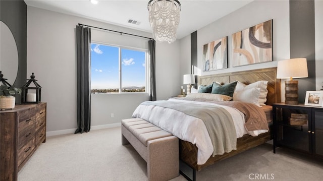 carpeted bedroom featuring a notable chandelier