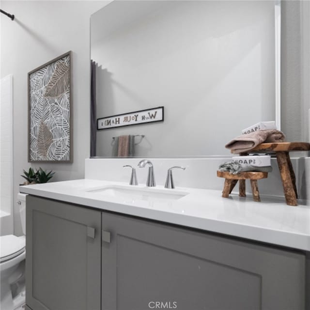 full bathroom featuring vanity,  shower combination, and toilet