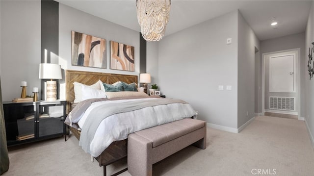 bedroom featuring light carpet and a chandelier