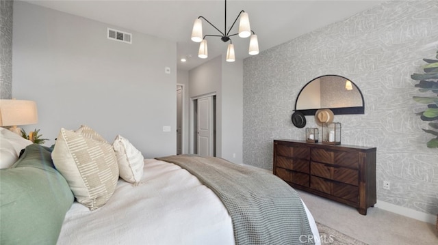 carpeted bedroom featuring an inviting chandelier