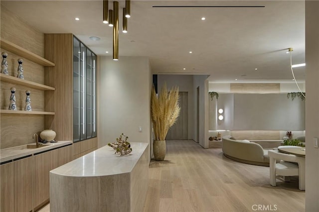 interior space with light wood-style floors, recessed lighting, and pendant lighting