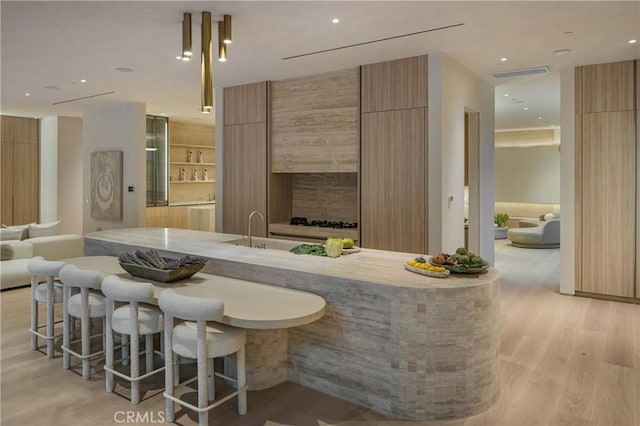 bar with recessed lighting, visible vents, and light wood-style flooring