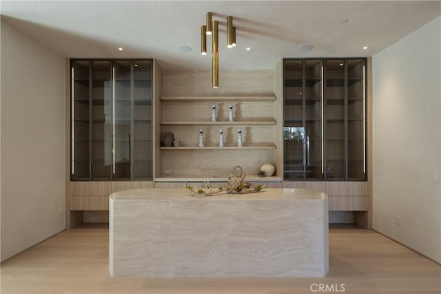 bar featuring light wood-type flooring and recessed lighting