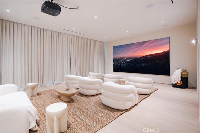 home theater room with light wood-style floors and recessed lighting