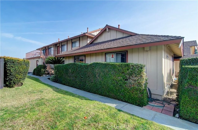 view of side of home featuring a lawn