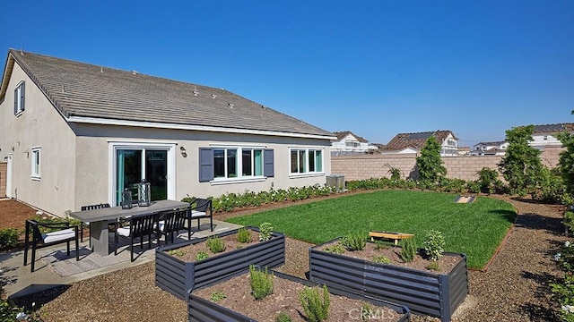 back of house with a patio and a lawn