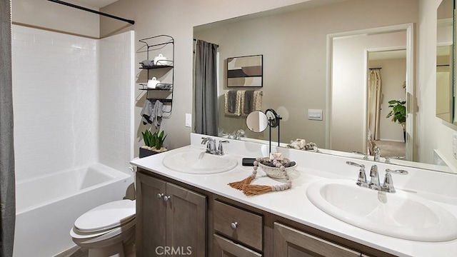 full bathroom featuring vanity, shower / bath combination with curtain, and toilet