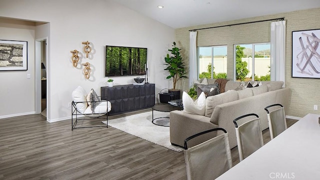 living room with dark hardwood / wood-style flooring and vaulted ceiling