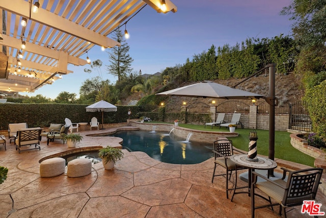 pool at dusk featuring a patio, pool water feature, and a pergola