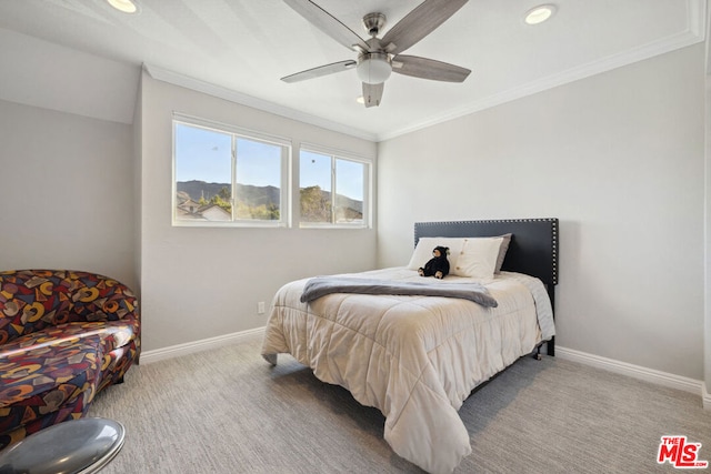 carpeted bedroom featuring ornamental molding and ceiling fan