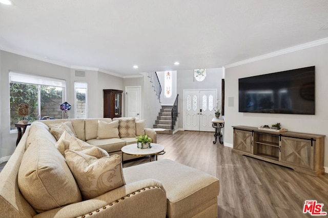 living room featuring wood-type flooring and ornamental molding