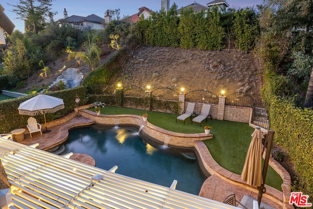 pool at dusk with a yard