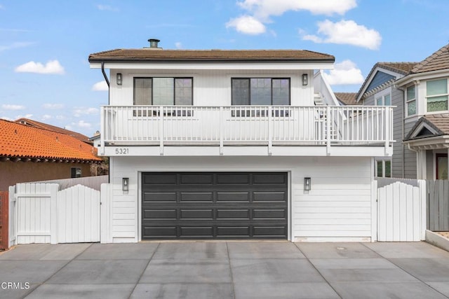 view of front of house with a garage and a balcony