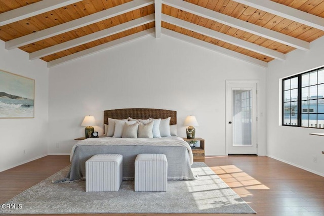 bedroom featuring dark wood-type flooring, lofted ceiling with beams, and wooden ceiling