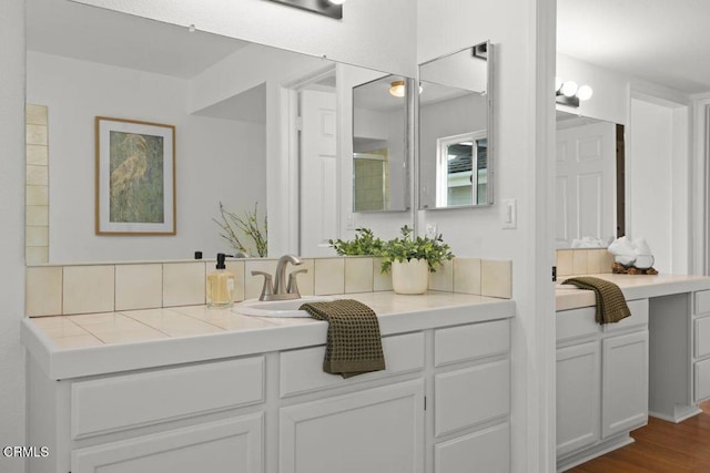 bathroom with hardwood / wood-style flooring and vanity