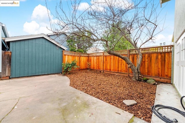 view of yard with a shed and a patio