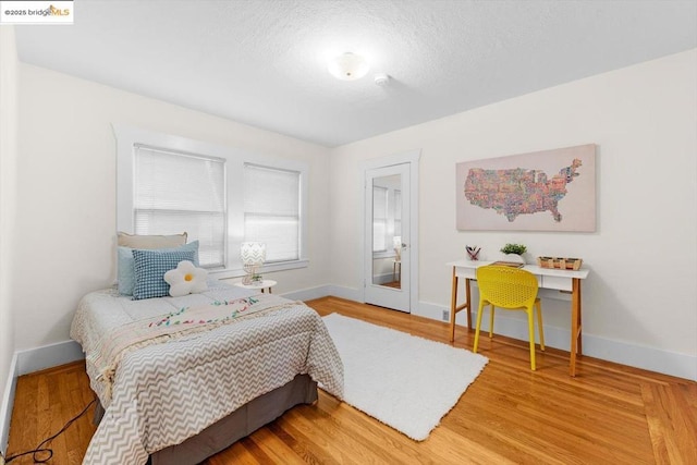 bedroom with hardwood / wood-style floors