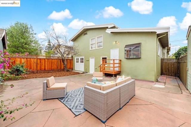 back of property featuring a patio and an outdoor hangout area