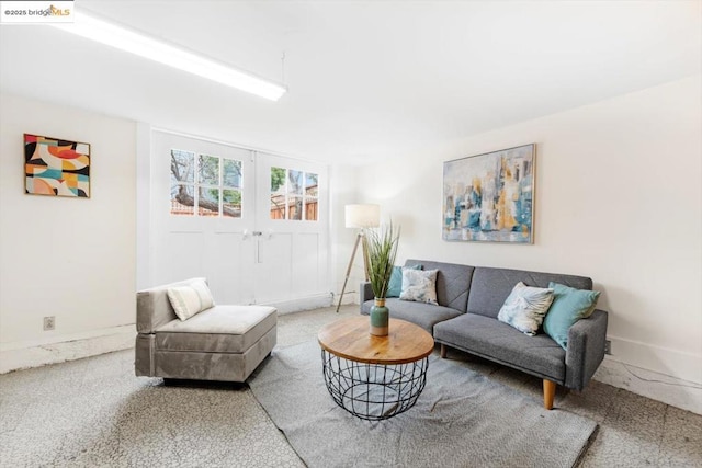 living room featuring french doors and carpet flooring