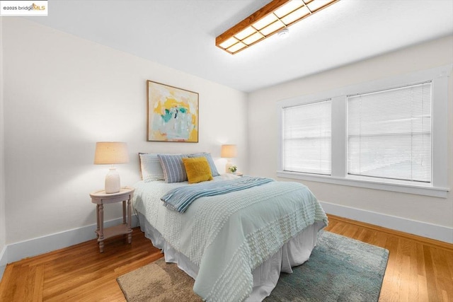 bedroom with hardwood / wood-style floors