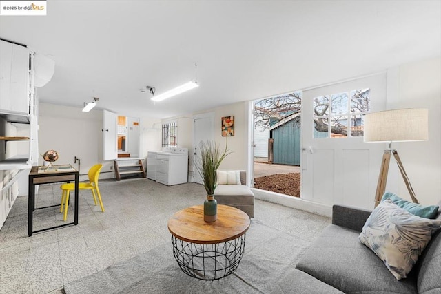 living room with washer and clothes dryer