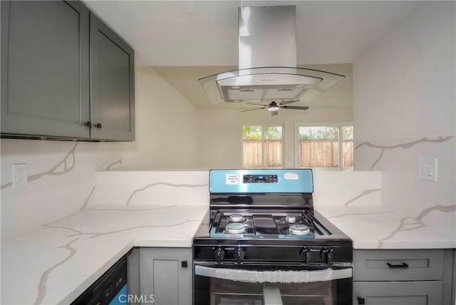 kitchen featuring ceiling fan, gray cabinetry, light stone counters, island range hood, and black appliances