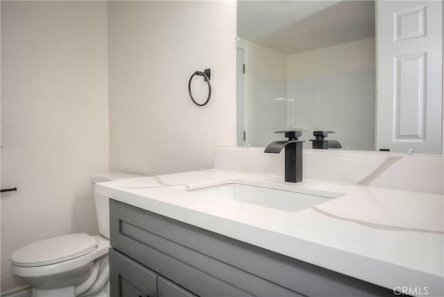 bathroom featuring vanity and toilet