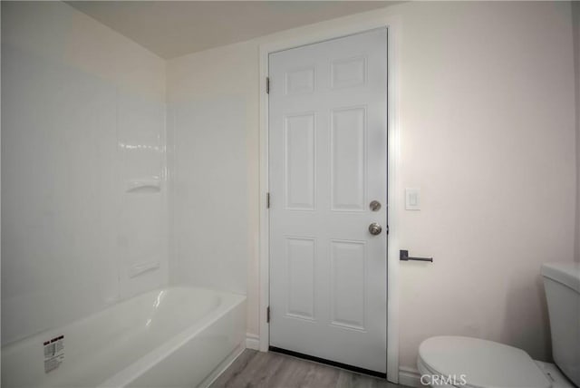 bathroom featuring wood-type flooring and toilet