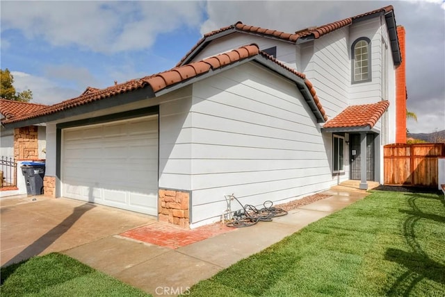 view of home's exterior with a garage and a lawn