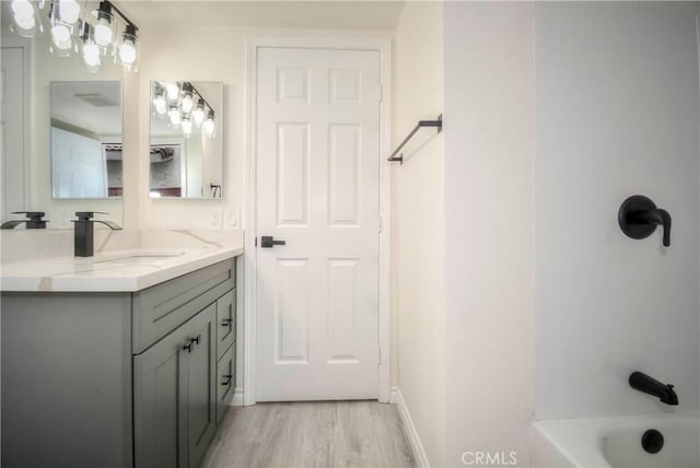 bathroom featuring vanity, hardwood / wood-style floors, and shower / bathing tub combination