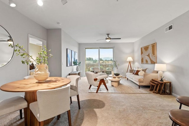 living room featuring light colored carpet and ceiling fan