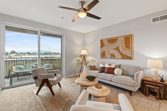 carpeted living room featuring ceiling fan