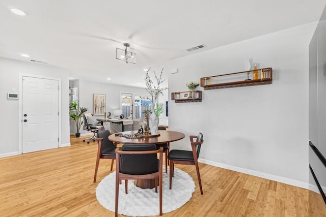 dining space with light hardwood / wood-style flooring