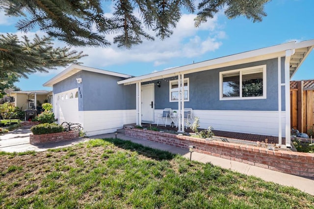 ranch-style house with covered porch and a front yard