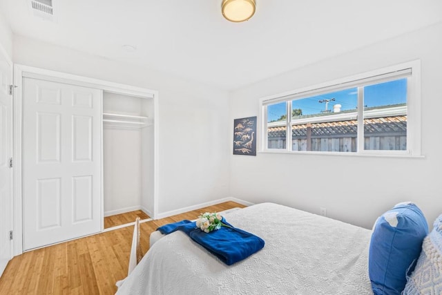 bedroom with wood-type flooring and a closet