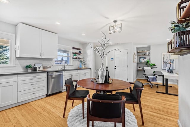 dining area with sink and light hardwood / wood-style floors