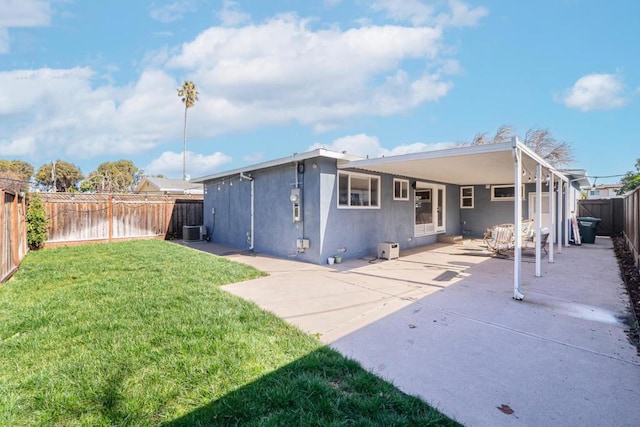 rear view of house with a patio area, a lawn, and central air condition unit