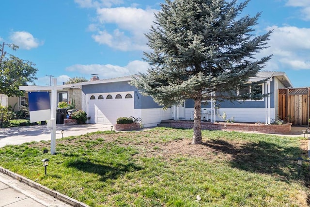 view of front facade with a garage and a front lawn