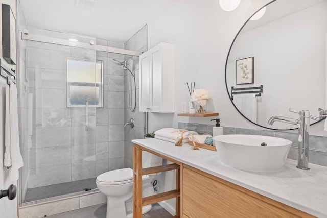 bathroom with vanity, toilet, and an enclosed shower