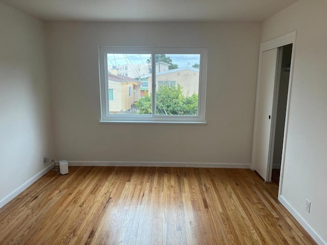 empty room with light hardwood / wood-style flooring