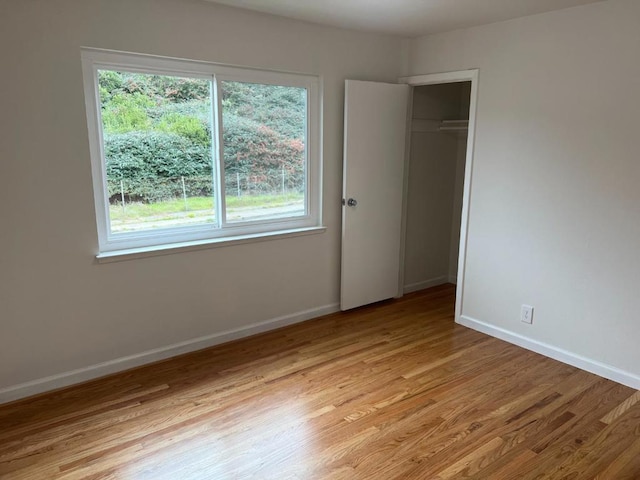 unfurnished bedroom with light hardwood / wood-style floors and a closet