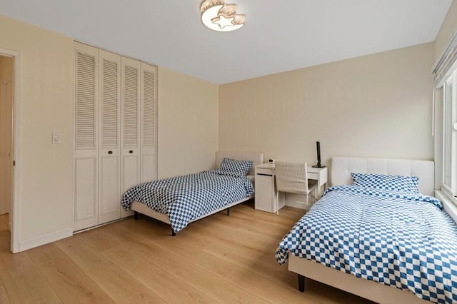 bedroom featuring light wood-type flooring and a closet