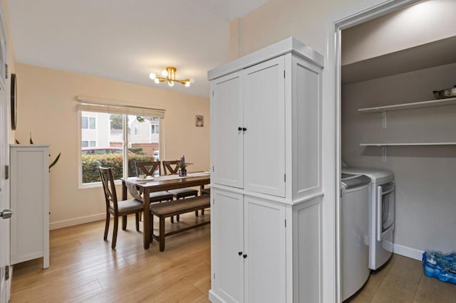 laundry room featuring washer and dryer and light hardwood / wood-style floors