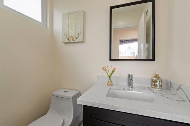 bathroom with vanity and toilet