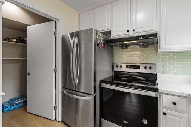 kitchen featuring backsplash, stainless steel appliances, light stone counters, light hardwood / wood-style floors, and white cabinets